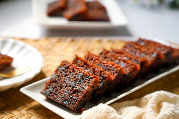 Kek Buah Kukus, a traditional Malaysian steamed fruit cake filled with dried fruits, nuts, and spices, enjoyed during celebrations.