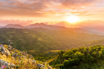 highland mountain landscape of beautiful sunset or sunrise with nice mountain peaks and slopes,...