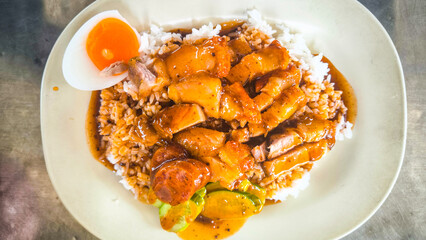 Crispy pork rice on a white plate on the dining table