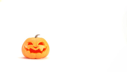 Halloween pumpkin smiles on white background with copyspace. Funny Jack o lantern Halloween backdrop