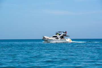 The pleasure boat with motor (yacht) on the Mediterranean Sea against the blue sky.