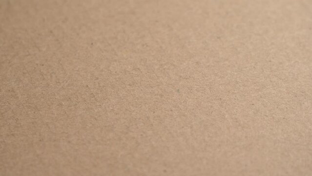 Fiber brown packaging box cardboard surface with corrugated texture close up. Rotation