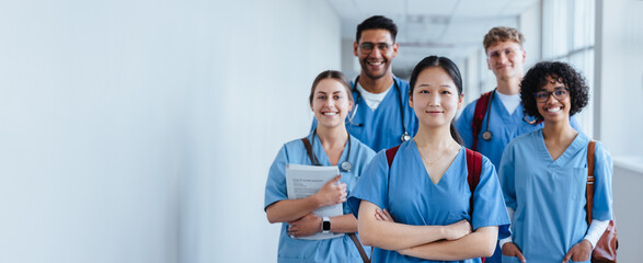 Diversity in medicine: Young medical students wearing scrubs in a hospital