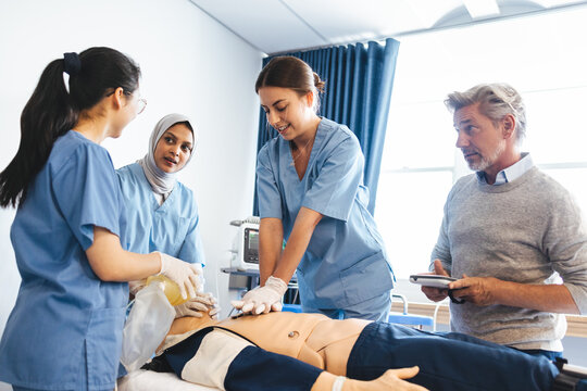 Students learning how to do chest compressions in nursing school