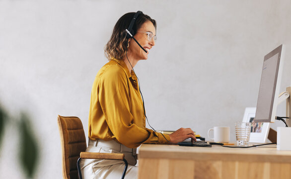 Happy call center agent providing remote customer assistance