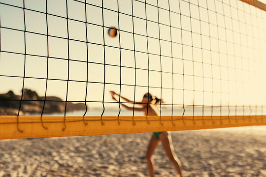 Passionate women's beach volleyball tournament at sunset