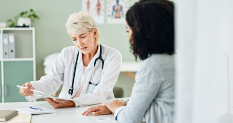 Mature woman, tablet and consulting with patient for medical results, diagnosis or prescription at...