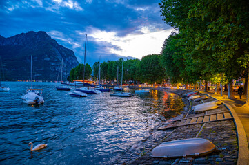 The lakefront of Lecco, photographed in the evening.