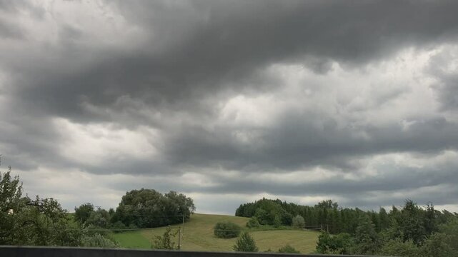 Opava, Hnevosice, stormy dark clouds, hill and heavy rain in the background, Czech landscape