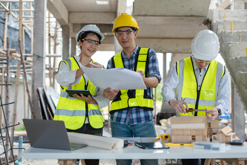 civil engineer and worker discussing issues at the construction site in the morning.