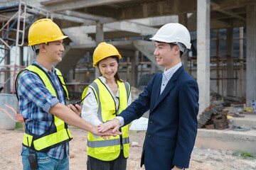 Team architects workers, men and women, join hands to join forces to join forces to work for the industry for success. Teamwork and professional colleagues : Workers' hands, teamwork concept.