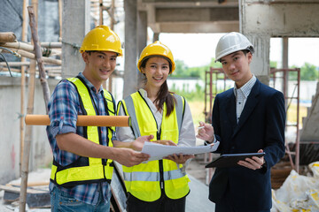 Construction engineers discussion with architects at construction site or building site.