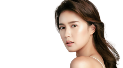 A beautiful young woman with long dark hair looks over her shoulder with a gentle smile.  Her skin is flawless and glowing.