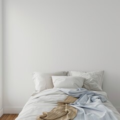 bed with white pillows in front of empty wall