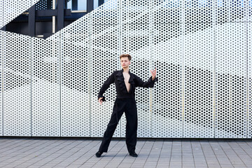 Athletic male dancer performing ballroom solo dance