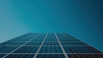 Obraz premium A field of solar panels under a clear blue sky, representing renewable energy solutions in environmental conservation
