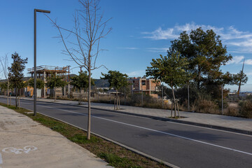 A street with a sidewalk and a bike lane