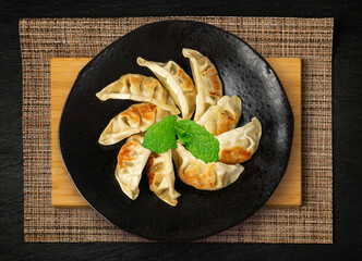 Gyoza Chinese Dumplings Top View, Vegetable Jiaozi, Chicken Momo Pile, Asian Gyoza Portion on Black