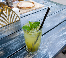 Tarragon lemonade in Georgian restauran, homemade herbal drink with ice, crushed estragon twigs