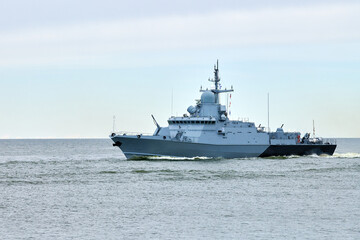Russian warship armed with armament sails into sea toward military target to attack and destroy...