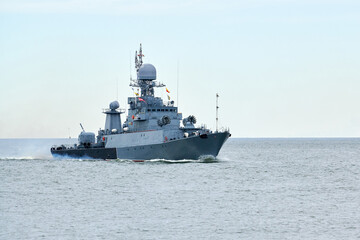 Russian warship armed with armament sails into sea toward military target to attack and destroy...
