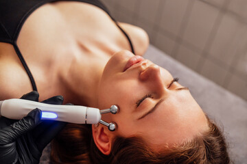 Microcurrent medicine treatment. Portrait of beautiful woman.