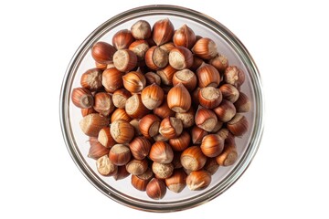 A clear glass bowl filled with various nuts on a clean white surface
