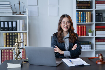 A female attorney is diligently working at her desk in the office.