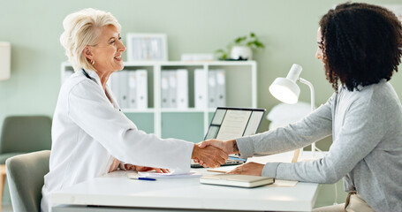 Mature woman, doctor and handshake with patient for consultation, agreement or checkup at hospital. Female person or medical professional shaking hands with client for meeting, deal or appointment