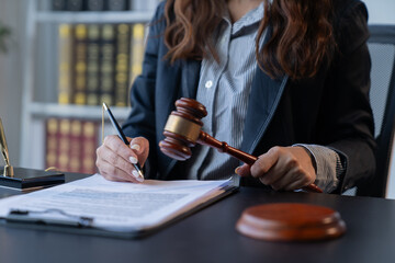 A female attorney is diligently working at her desk in the office.