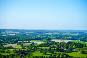 View of green farm fields and blue sky in the South of England