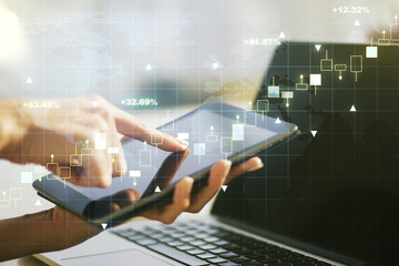 Multi exposure of abstract creative financial graph with world map and finger presses on a digital tablet on background, forex and investment concept