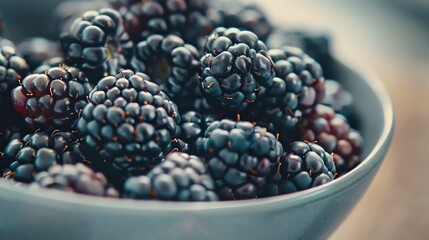 Plump blackberries, a low sugar fruit, in a bowl, highlighting their rich color and texture
