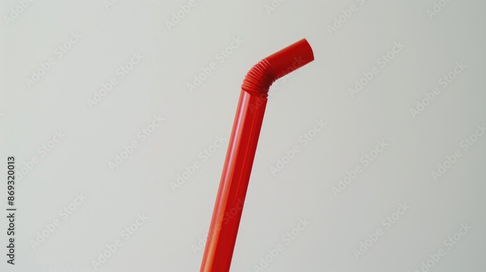 Poster a close-up image of a red plastic drinking glass with a straw sticking out of it