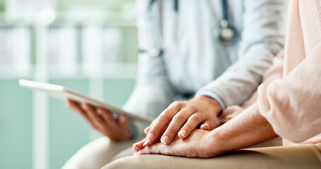Doctor, patient and holding hands with tablet at hospital with support, empathy and consultation....