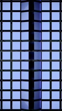 Abstract blue wall of same size squares with a vertical moving wave. Design. Cubic shaped background with a round light spot.