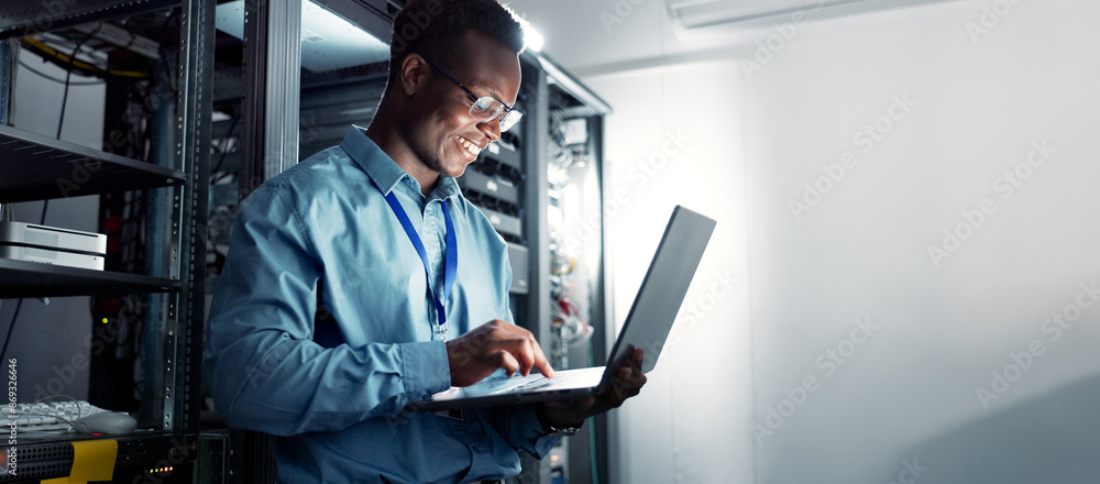 Poster Laptop, server room and black man on network for maintenance, programming software or typing. Tech, data center and happy engineer on system database for information, cybersecurity or cloud computing