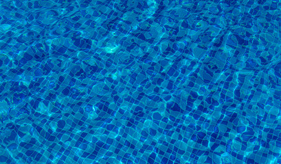 Beautiful sun reflections of water in the pool. Summer. Flight holidays.