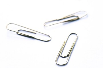 Metal clip. Minimalism office paper clip for important documents and files. White background, isolation.