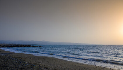 Cyprus beautiful sunset at the sea with rocks and cloudy sky
