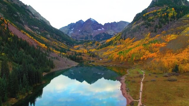 Aerial Forward Reflection Of Maroon Peak And North Maroon Peak In Lake During Autumn Season - Aspen, Colorado