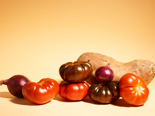 red farm tomatoes on a beige background