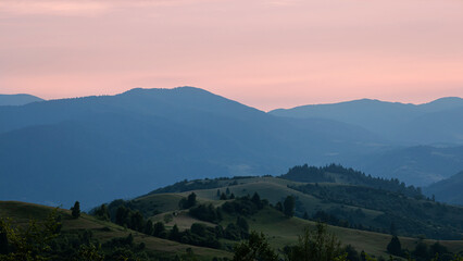 Beautiful sunset in the mountains. The early evening sun illuminates the mountains