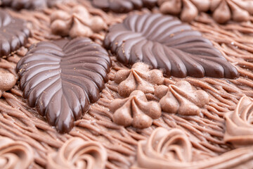 Chocolate bundt cake drizzled with chocolate ganache glaze.Front view of a triple layered chocolate cake .