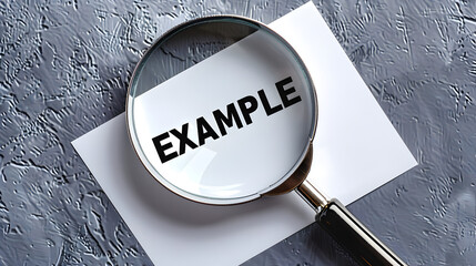 Magnifying Glass Highlighting the Word "Example" on Textured Background