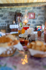A table with a candle and a glass of red wine