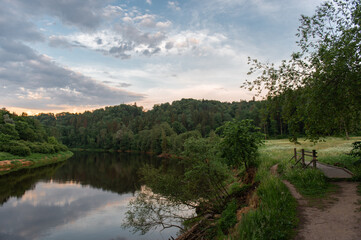 A beautiful landscape with Gauja River and wooden bridge over a footpath in Latvia, national park