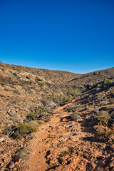 Walking track through the arid outback landscape of the Mandu Mandu Gorge in Cape Range National Park, Western Australia. 
