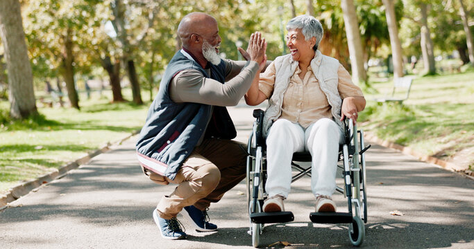 Senior, couple and high five in park for support fresh air, walking and enjoyment of retirement or wellness with love. Man, outdoor and woman with disability in garden for bonding, together and win