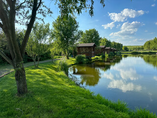 Obraz premium Discover the perfect fishing spot on our serene lake. Enjoy tranquil surroundings, clear waters, and the thrill of the catch. Ideal for a relaxing day in nature with friends and family.